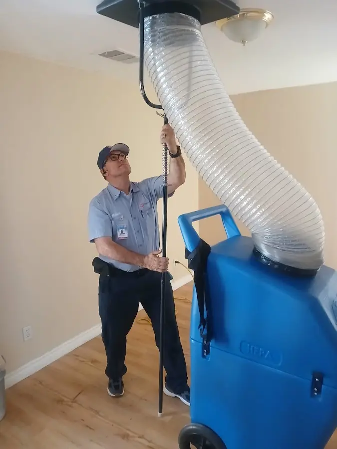 Furnace Tune-Up technician using HEPA equipment in Rehoboth